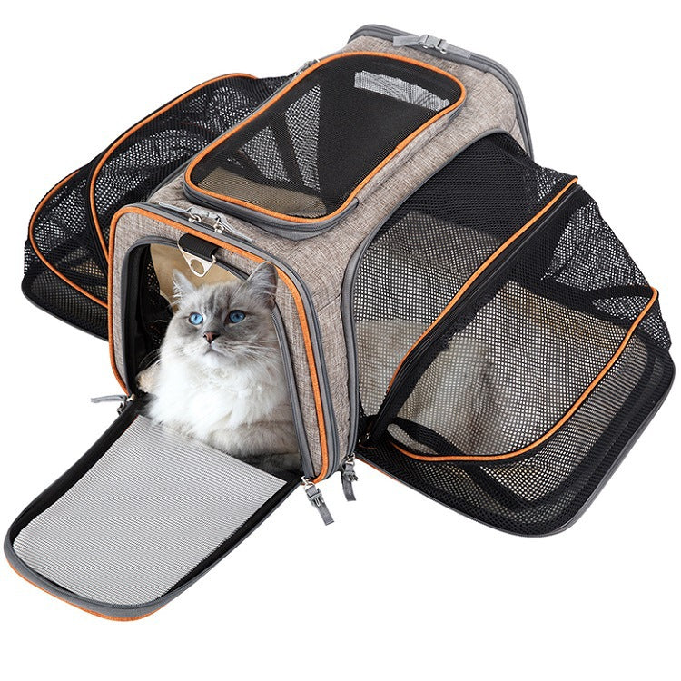 Orange expandable pet carrier opened with breathable mesh extensions for travel waiting time
